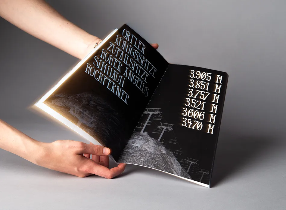 Schriftanwendungen anhand von Bergen und deren Höhe. Hinter der Schrift ist ein invertiertes Bild eines Sessellifts.